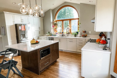 Inspiration for a large transitional u-shaped eat-in kitchen remodel in Other with shaker cabinets, quartz countertops, mosaic tile backsplash and an island