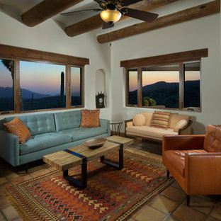 This is an example of a mid-sized mediterranean master bedroom in Phoenix with white walls and terra-cotta floors.