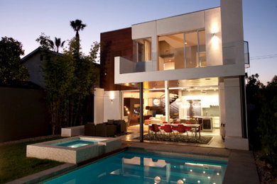 Large contemporary two-storey beige exterior in Los Angeles with mixed siding and a flat roof.
