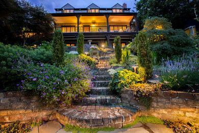 Inspiration for a large traditional backyard full sun formal garden for spring in Seattle with brick pavers and a garden path.