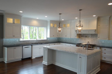 Example of a large transitional l-shaped open concept kitchen design in New York with an undermount sink, shaker cabinets, gray backsplash, stainless steel appliances and an island