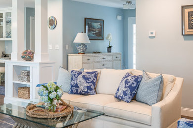 Large beach style open concept dark wood floor living room photo in Providence with blue walls