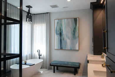 Inspiration for a large porcelain tile, white floor and double-sink bathroom remodel in Tampa with shaker cabinets, black cabinets, a bidet, gray walls, an undermount sink, quartz countertops, a hinged shower door, white countertops and a built-in vanity