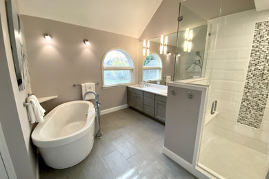 Large transitional master ceramic tile, gray floor and double-sink bathroom photo in Philadelphia with flat-panel cabinets, gray cabinets, a two-piece toilet, gray walls, an undermount sink, quartz countertops, white countertops and a built-in vanity
