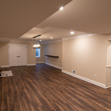 Basement Showing Warm Colors, Straight Lined Cabinets and Stacked Stone