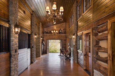 Hallway - large rustic concrete floor and brown floor hallway idea in Nashville with brown walls