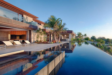Large trendy backyard concrete paver and rectangular infinity hot tub photo in San Diego
