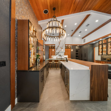 Dual Waterfall Islands and Statement Lighting in Entertainer’s Kitchen