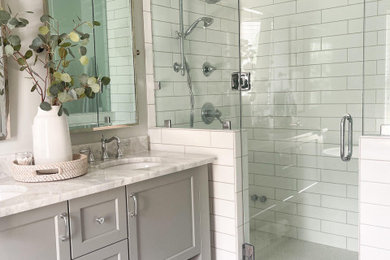 Inspiration for a transitional master white tile and ceramic tile white floor and double-sink bathroom remodel in Other with furniture-like cabinets, gray cabinets, gray walls, an undermount sink, quartzite countertops, a hinged shower door, white countertops and a freestanding vanity
