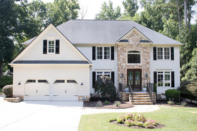 Elegant white two-story concrete fiberboard and clapboard house exterior photo in Raleigh