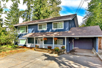 Inspiration for a mid-sized contemporary blue two-story wood gable roof remodel in Vancouver
