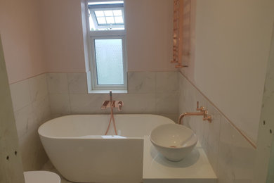 This is an example of a modern bathroom in West Midlands with a freestanding bath.