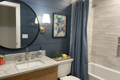 Example of a mid-sized transitional single-sink bathroom design in Raleigh with quartzite countertops and a built-in vanity