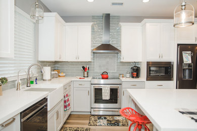 Example of a transitional kitchen design in Sacramento with gray backsplash, brick backsplash, an island and white countertops