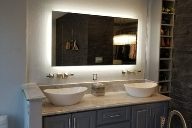 Large elegant master gray tile and marble tile marble floor and white floor bathroom photo in Houston with shaker cabinets, gray cabinets, an urinal, gray walls, a vessel sink, marble countertops and a hinged shower door