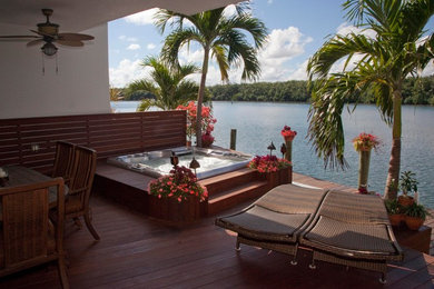 Inspiration for a mediterranean courtyard rectangular aboveground hot tub remodel in Miami with decking