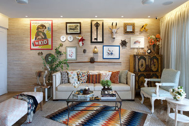 Inspiration for an eclectic living room in Mumbai with beige walls, medium hardwood floors and no tv.