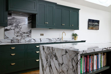 Design ideas for a mid-sized transitional kitchen in London with shaker cabinets, green cabinets and with island.