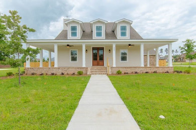Inspiration for a mid-sized transitional beige two-story wood house exterior remodel in Miami with a shingle roof