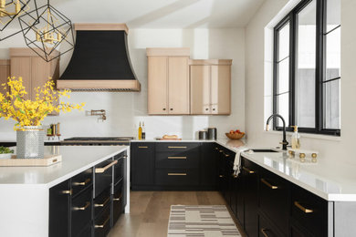 Inspiration for a huge transitional u-shaped light wood floor and beige floor eat-in kitchen remodel in St Louis with an undermount sink, shaker cabinets, black cabinets, quartz countertops, white backsplash, ceramic backsplash, black appliances, an island and white countertops
