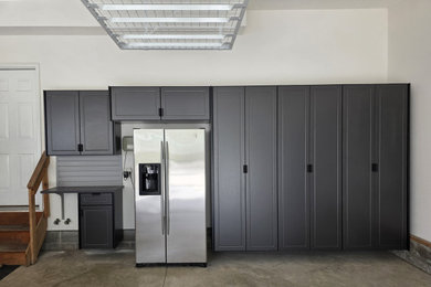 Example of a large attached three-car garage design in Cleveland