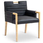 Meridian Furniture - Aimee Upholstered Dining Arm Chair, Black, Vegan Leather, Natural - A perfect fusion of modern elegance and eco-friendly luxury is the Aimee black vegan leather dining armchair. Upholstered in sleek vegan leather, this chair offers a chic, contemporary look while maintaining a commitment to sustainable living. The padded, quilted design featuring solid natural oak wood legs and armrests creates a stunning contrast between its soft upholstery and minimalist frame.
