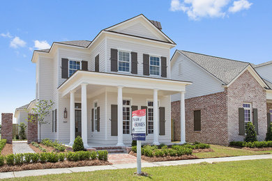 Example of a large classic white two-story mixed siding gable roof design in New Orleans