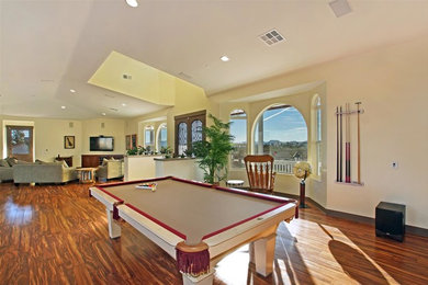 Inspiration for a mid-sized timeless open concept medium tone wood floor living room remodel in Las Vegas with yellow walls, no fireplace and a wall-mounted tv