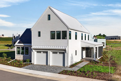 Farmhouse white two-story mixed siding exterior home idea in Other with a metal roof and a white roof