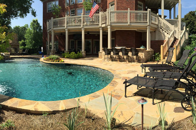 Inspiration for a backyard stone and custom-shaped natural hot tub remodel in Atlanta