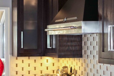 Enclosed kitchen - small transitional u-shaped porcelain tile enclosed kitchen idea in San Francisco with an undermount sink, recessed-panel cabinets, dark wood cabinets, quartz countertops, white backsplash, porcelain backsplash, stainless steel appliances and a peninsula