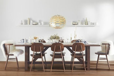 Design ideas for a mid-sized scandinavian open plan dining in Portland with white walls, medium hardwood floors, no fireplace and brown floor.