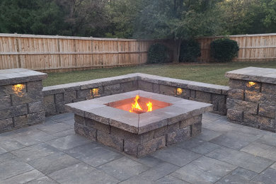 Inspiration for a small contemporary backyard concrete paver patio remodel in Charlotte with a fire pit and no cover