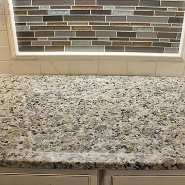 Beige Kitchen with Extra Large Island, Tile Backsplash and Granite Countertops