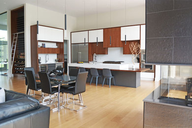 Trendy light wood floor kitchen photo in Ottawa with flat-panel cabinets, white backsplash, quartz backsplash and an island