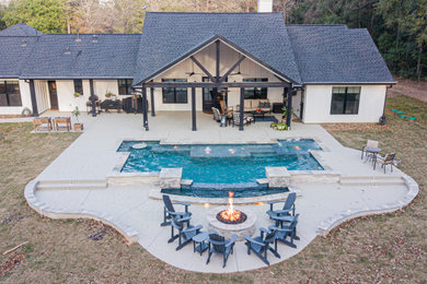 Pool - large farmhouse backyard rectangular pool idea in Houston with decking