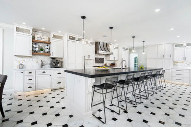Inspiration for a huge l-shaped porcelain tile and white floor eat-in kitchen remodel in Other with an undermount sink, shaker cabinets, white cabinets, granite countertops, white backsplash, ceramic backsplash, stainless steel appliances, two islands and black countertops