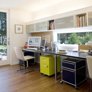 Inspiration for a modern home office and library in New York with bamboo flooring.