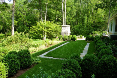 This is an example of a mid-sized traditional side yard shaded garden for winter in New York with a garden path and natural stone pavers.