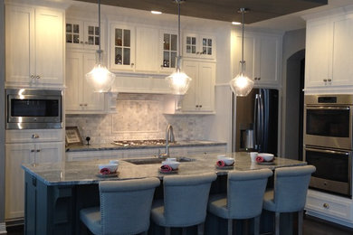 Inspiration for a mid-sized transitional single-wall dark wood floor and brown floor eat-in kitchen remodel in Minneapolis with an undermount sink, shaker cabinets, white cabinets, granite countertops, gray backsplash, stone tile backsplash, stainless steel appliances and an island