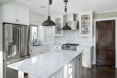 Trendy eat-in kitchen photo in Chicago with an undermount sink, recessed-panel cabinets, white cabinets, stainless steel appliances and an island