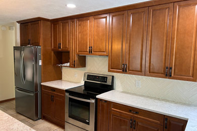 Example of a mid-sized classic l-shaped eat-in kitchen design in Indianapolis with medium tone wood cabinets, quartz countertops and subway tile backsplash