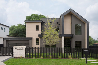 Inspiration for a transitional two-story mixed siding gable roof remodel in Austin with a metal roof and a black roof