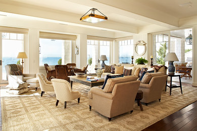 This is an example of a beach style living room in Los Angeles with beige walls, dark hardwood floors, no fireplace and no tv.