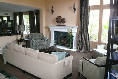 Living room - mid-sized traditional formal and open concept carpeted living room idea in Orange County with beige walls, a standard fireplace, a plaster fireplace and no tv