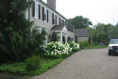 Inspiration for a large traditional front yard partial sun driveway in New York with a garden path and gravel.