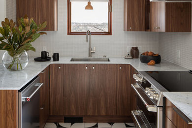 Design ideas for a mid-sized midcentury u-shaped kitchen in Seattle with flat-panel cabinets, medium wood cabinets, quartz benchtops, white splashback, no island and white benchtop.