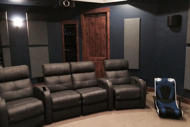 Example of a classic carpeted home theater design in Denver with blue walls