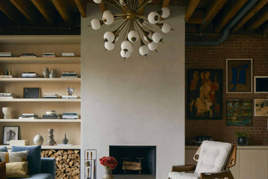Inspiration for a large industrial loft-style light wood floor, beige floor, exposed beam and brick wall living room remodel in New York with a wood stove, a plaster fireplace and no tv