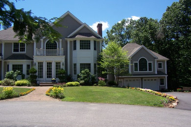Example of a large classic gray two-story wood exterior home design in Boston with a clipped gable roof
